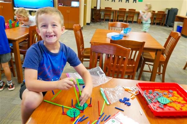 student with colorful blocks